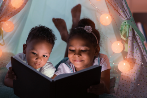 Children reading in indoor tent