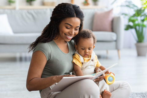 Adult reading to child in their lap