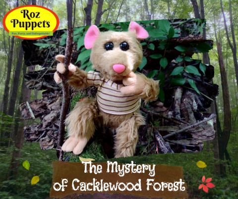 Mousepuppet in the woods with text "the mystery of cacklewood forest"