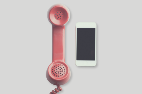 Traditional pink landline phone and smartphone