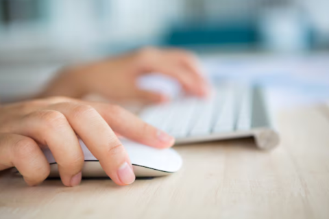 Hands operating a keyboard and mouse