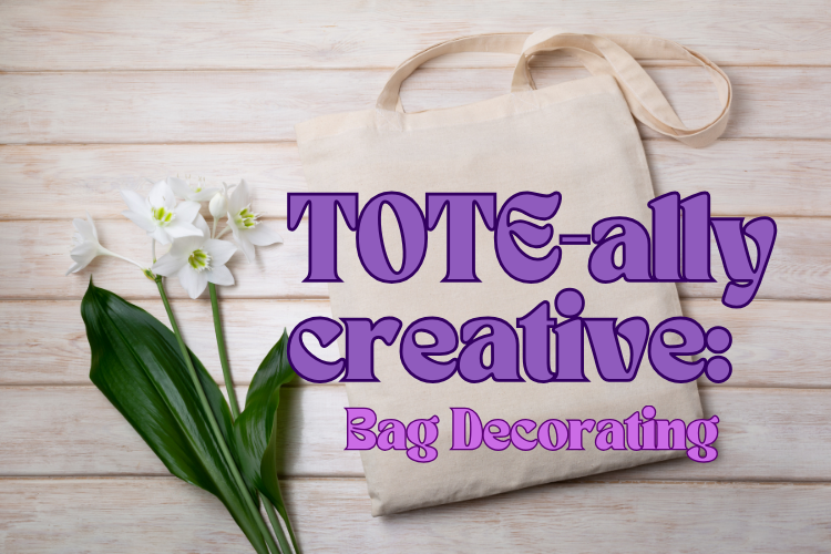 Tote bag on a wooden background with a white flower with words tote-ally creative bag decorating